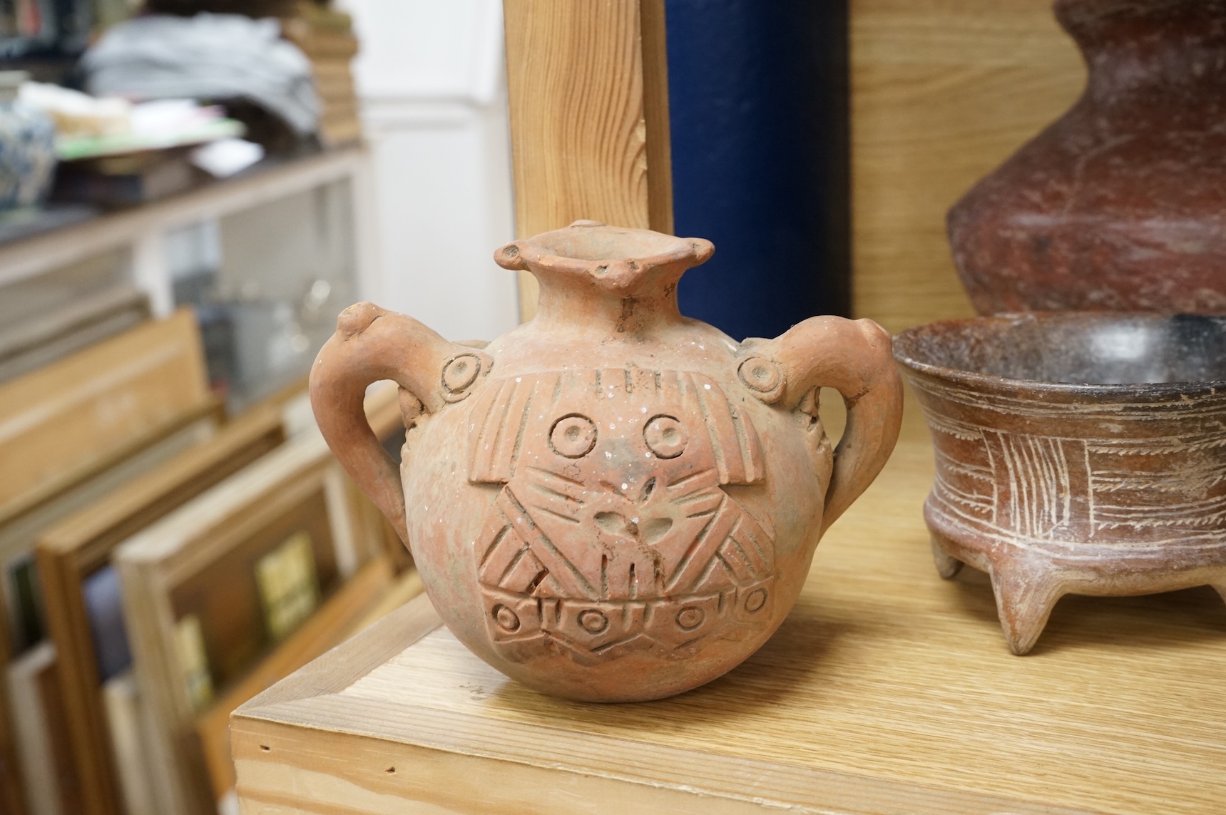 A collection of various South American vessels some in the form of grotesque heads, largest 24cm wide